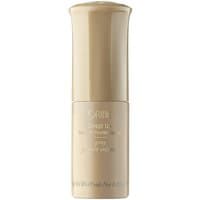 Beige Oribe volume powder spray bottle with curved cap and sleek design, 4.5 g size.