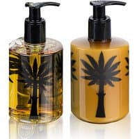 Ortigia Ambra Nera body cream and liquid soap, amber bottles with black palm tree design, pump dispensers, 300 ml each.