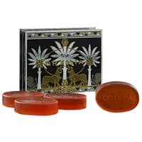Ortigia Ambra Nera glycerine soap kit with four amber oval soaps and ornate black box featuring palm trees.