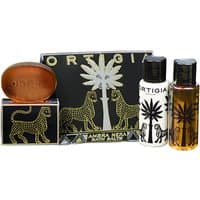 Ortigia Ambra Nera gift set with black and gold packaging, includes soap, lotion, and oil with leopard design.