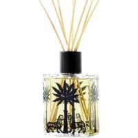 Clear glass diffuser with black palm tree design, filled with yellow liquid, topped with natural reeds.