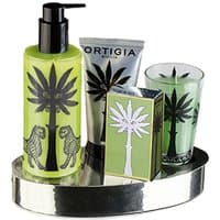 Ortigia Fico d'India gift set with green lotion, cream, soap, and candle on silver oval tray, palm tree design.