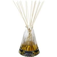 Clear glass Ortigia Florio diffuser with golden liquid and multiple thin reed sticks.