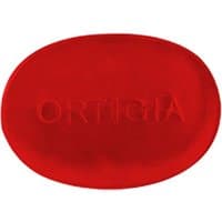 Red oval Ortigia Melograno glycerine soap with embossed brand name.