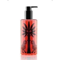 Red Ortigia Melograno shower gel bottle with black palm tree and leopard design, black pump top.