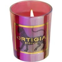 Ortigia Palo Santo Rosso candle in red glass with black leopard design and gold lettering.