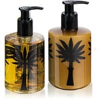 Ortigia Zagara body cream and liquid soap, amber and gold bottles with black palm tree design, pump dispensers.