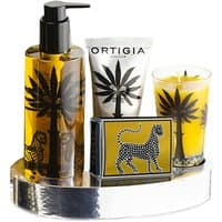 Ortigia Zagara gift set with lotion, cream, candle, and soap, featuring black palm tree design on a silver oval tray.