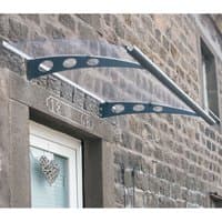 Clear arched door canopy with black brackets and circular cutouts, mounted above a stone doorway.