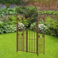 Brown metal garden arch with gate, circular rosette design, and side planters, measuring 7'4" x 4'1".