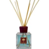 Square glass bottle with brown cap, filled with blue liquid, and reed sticks; Profumo di Campiglio diffuser.