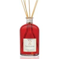 Red glass bottle of Salentum Aria di Natale diffuser with wooden reeds and white label.