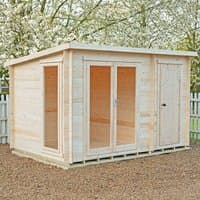 Wooden log cabin with glass double doors and side shed, flat roof, natural finish, set on gravel with white fence backdrop.